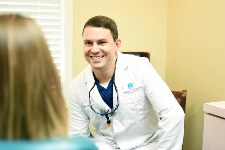 Dr. Travis Coleman talking to a dental patient.